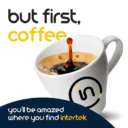 A cup of coffee sitting on its edge after being knocked